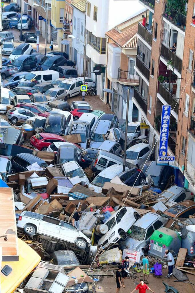 Cars piled up on a street in Valencia, Spain after its worst flood in a century