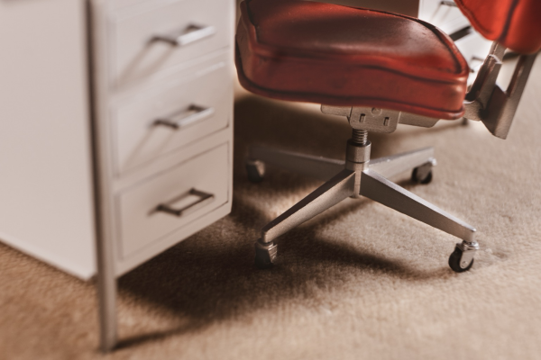 A miniature 1:12 scale model of a check, close up, under a white desk