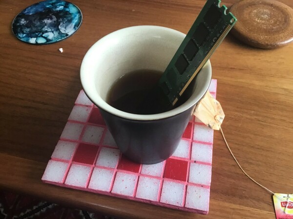 Photo of a cup of tea with SDRAM sitting in the drink